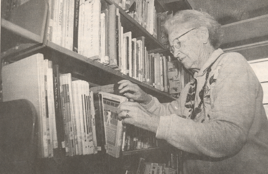 Bessie Hall checks books on the shelves at the Alexander Young Elementary library.